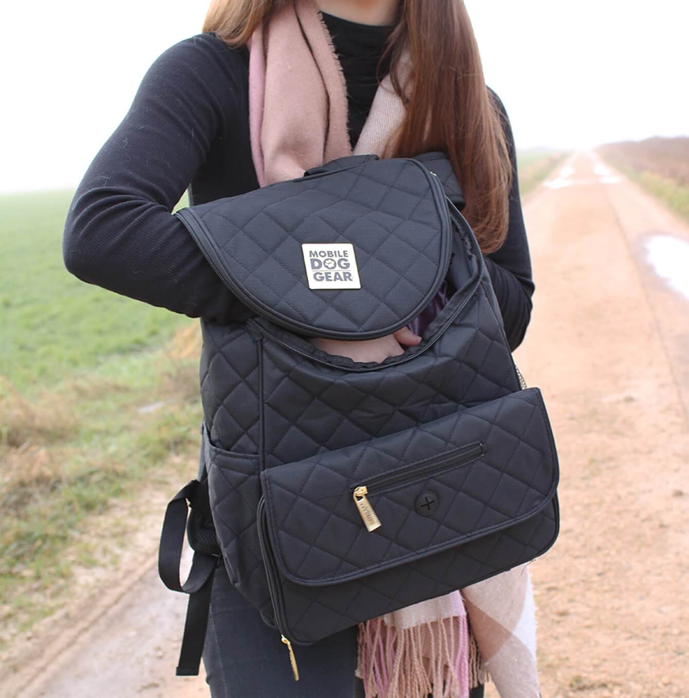Discover, Mobile Dog Gear Weekender Backpack, in Black. The Perfect Away Bag for any Pet Parent, Featuring dividers to stack food and built in waste bag dispenser. Also Included feeding set, collapsible silicone bowls and placemat! The Perfect Gift For travel, meets airline requirements. Available Now at Lords & Labradors US