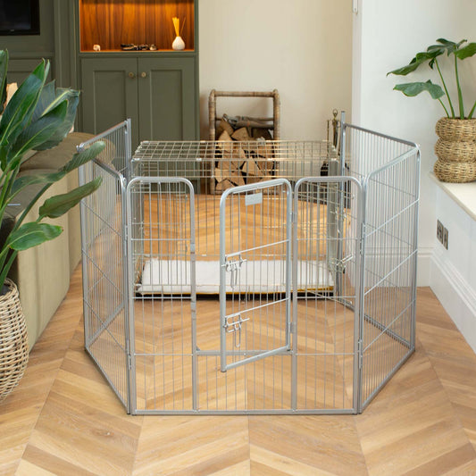 Ensure The Ultimate Puppy Safety with Our Heavy Duty 80cm High Silver Metal Play Pen, Crafted to Take Your Pet Right Through Maturity! Powder Coated to Be Extra Hardwearing! 6 panels that are 80cm high and attachments to connect to any cage. The modular system allows you to change the puppy pen shape with multiple layouts! Available To Now at Lords & Labradors US