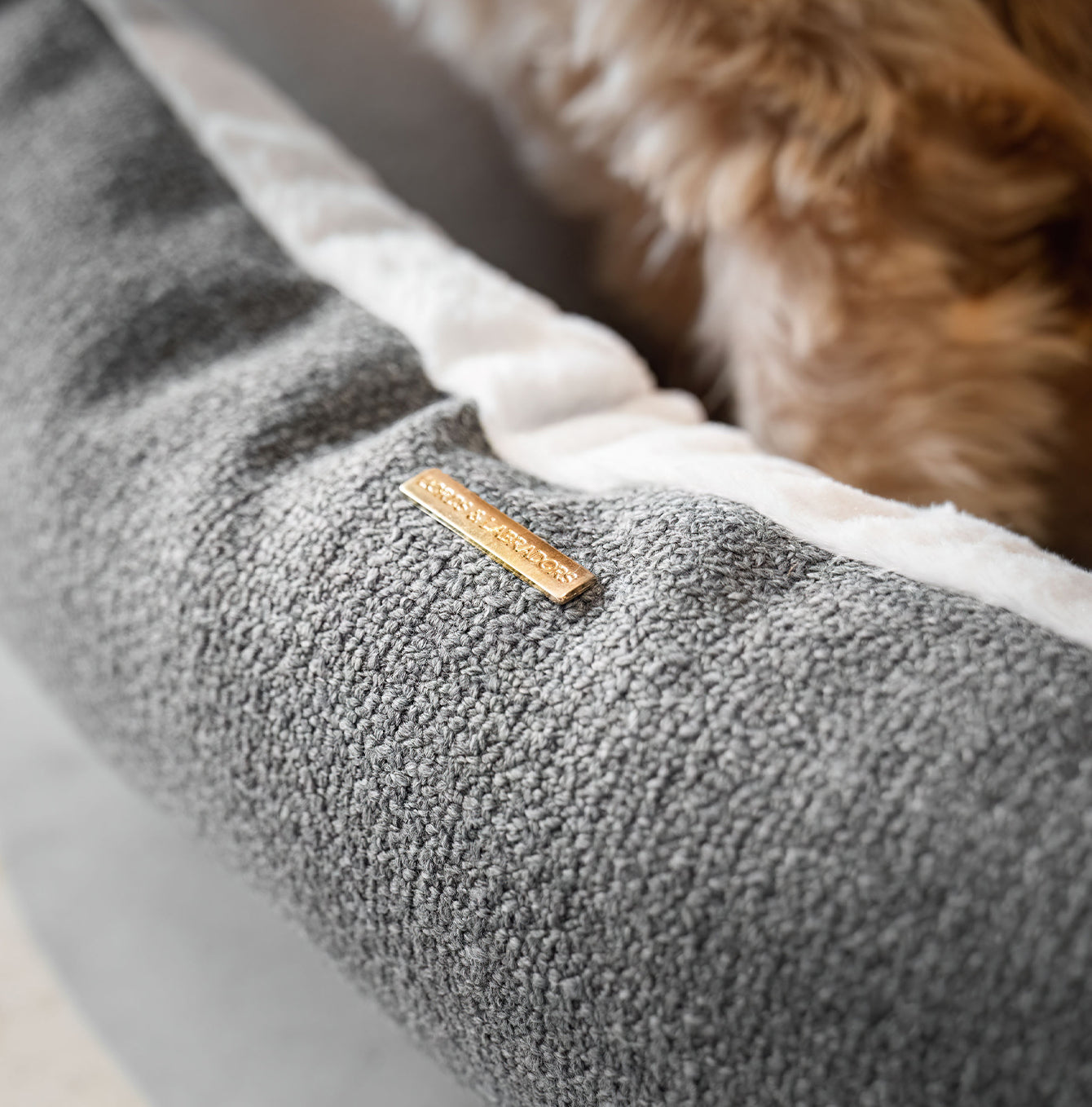 Present your furry friend with our luxuriously thick, plush Essentials Herdwick Box Bed in Graphite. Featuring a reversible inner cushion, along with Convenient carry handles on either side. This is a hardwearing woven fabric handmade in Italy for the perfect high-quality. now available at Lords and Labradors US