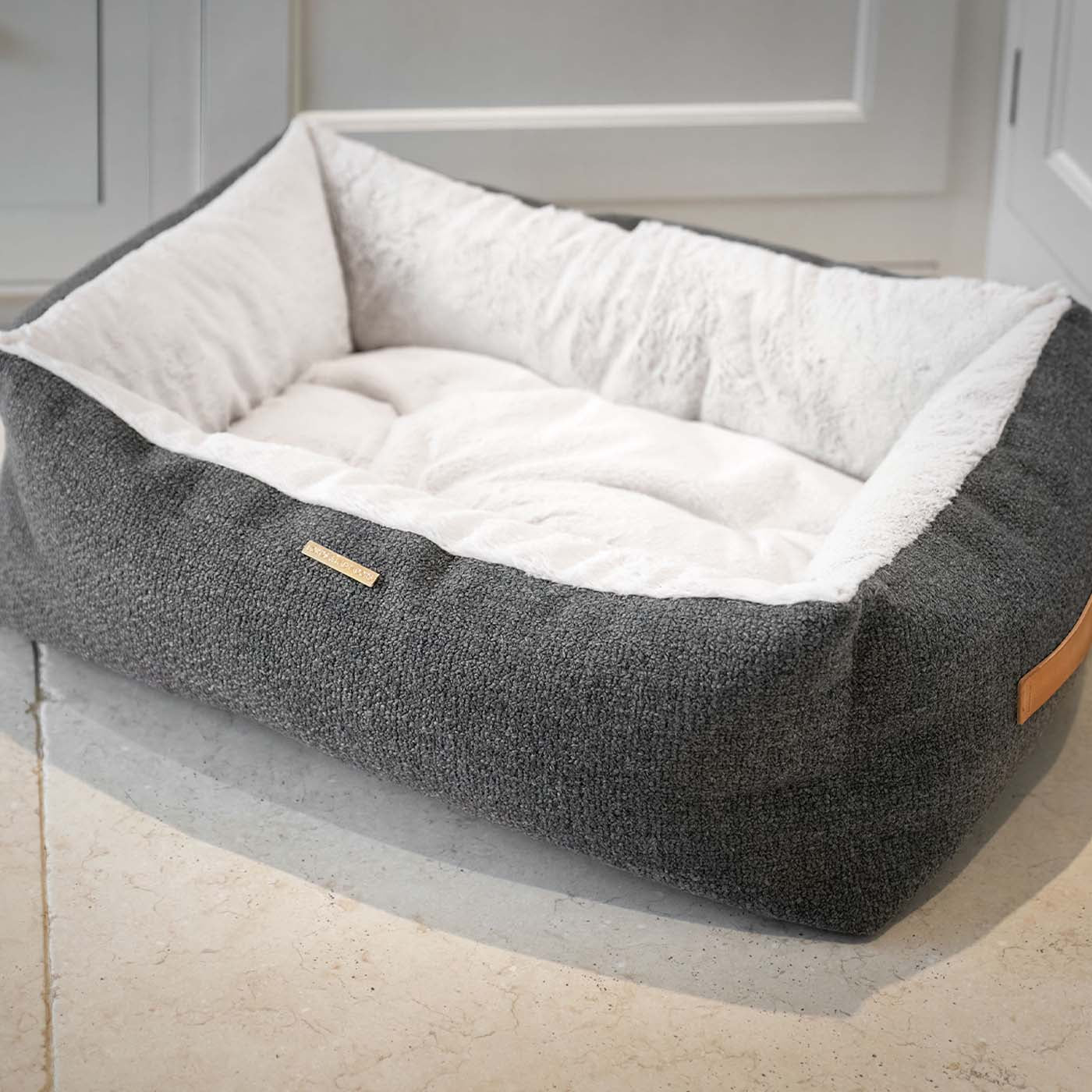 Present your furry friend with our luxuriously thick, plush Essentials Herdwick Box Bed in Graphite. Featuring a reversible inner cushion, along with Convenient carry handles on either side. This is a hardwearing woven fabric handmade in Italy for the perfect high-quality. now available at Lords and Labradors US